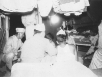 Recreation - poker game. Taken at night. Old camp. [Courtesy of Bert Hamakado]