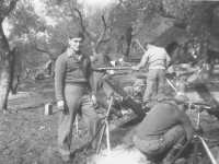 Soldiers gather around to listen to a Red Cross woman speak. [Courtesy of Mary Hamasaki]