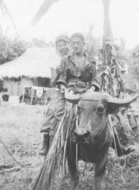 Tom Matsumura and a friend ride a carabao in the Philippines. [Courtesy of Florence Matsumura]