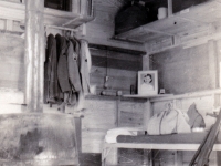 (August 30, 1942) My bunk is next to me inside of tent.  Wooden boards are for protection when it snows and rains.  Eugene Kawakami inside of his tent at Camp McCoy, Wisconsin, while he waits for his laundry to dry.  [Courtesy of Joanne Kai]