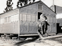 (September 1942) Eugene Kawakami posing in front of the "old camp" at Camp McCoy, Wisconsin.  The men of the 100th Infantry Battalion were able to move out of the tents, and into military barracks around this time.  [Courtesy of Joanne Kai]