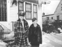 Corrine and Kay Falke wearing Army covers while at Aunt Vi's and Uncle Bill's house in LaCrosse, Wisconsin, winter 1942. [Courtesy of Mieko Muroshige]