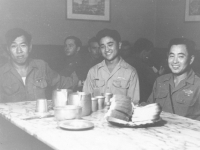 Conrad Kurahara (middle) with friends at dinner in Italy. [Courtesy of Jane Kurahara]