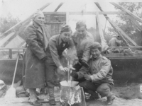 Haya, PeeWee, Woppy.  Taken Sept. 24, 1942 at Old Camp McCoy,on moving day.  Another group picture. Constantly 37 degrees  cold and snow.  L To R Haruo Hayakawa, George Hirata, Stanley Imamura and myself.  Note everybody, except one, with gloves (woolen ones) on.   It snowed snowflakes for the first time that afternoon.  [Courtesy of Jan Nadamoto]