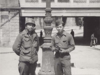 Lawrence Iwamoto and Tatsuo Suzuki pose near a street sign in Novi Ligure, Italy. [Courtesy of Fumie Hamamura]