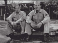 Ralph Fukunaga and Stanley Hamamura sit in front of building. [Courtesy of Fumie Hamamura]