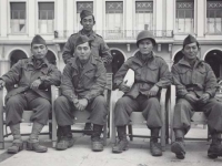 Picture of Stanley Hamamura with friends. The white package my friend is holding contained 3 days supply of cigarette butts - mixed with some tobacco (pipe) and sold to the French man for $5.00 nice, Nov. ‘44 France. [Courtesy of Fumie Hamamura]