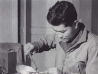 Hiyane fixing his radio, 1945. [Courtesy of Fumie Hamamura]