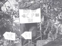 Tom Nosse standing at the 100th Bn. Camp sign in Leghorn, Italy. [Courtesy of Fumie Hamamura]