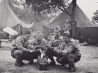 Kaoru Naito, Calvin Shimogaki, Suyeoshi and Hisashi Komori warming themselves by a fire at Camp McCoy in June 1942. [Courtesy of Fumie Hamamura]