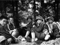 Morihara, Miyashiro, Grennie, Takahashi, Hirokawa, and Himura resting after a hike at Camp McCoy, July 1942 [Courtesy of Fumie Hamamura]