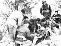 Group of soldiers sitting and 'shootin craps' [Courtesy of Sonsei Nakamura]