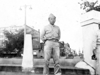 Tokuji Ono standing with hands behind his back along a street [Courtesy of Leslie Taniyama]