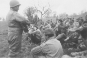 Charlie Diamond, of Hawaiian descent whose parents had lived in Japan for awhile, plays guitar for fellow troops of the 100th Battalion. [Courtesy of Thelma Chang]